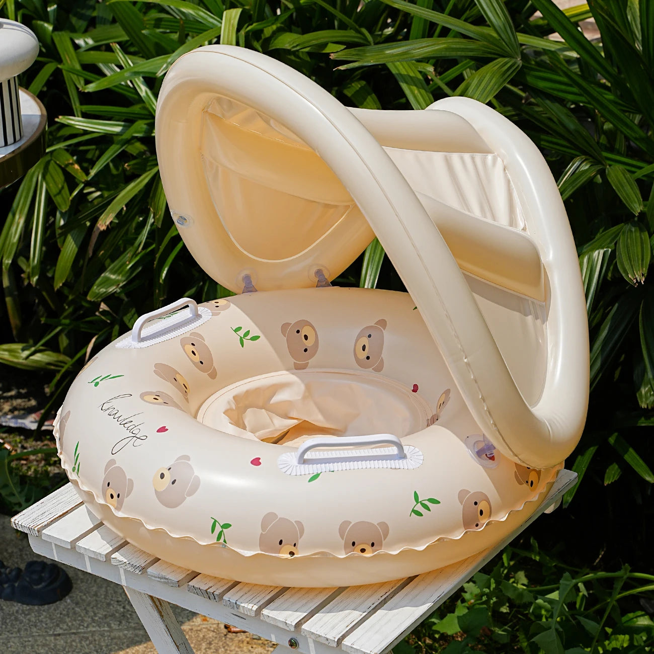 Inflatable swimming float with seat